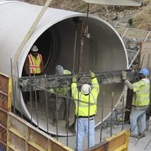 Technicians Working in Large Pipe