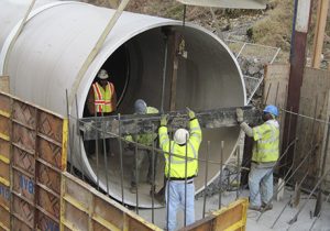 Technicians Working in Large Pipe