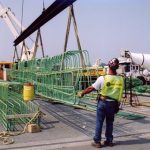 Worker Extending Length of Pier Replacement Pieces
